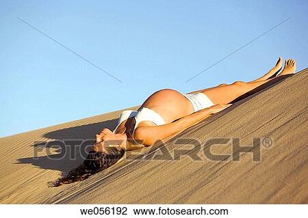 Pregnant Woman Lying on a Sand Dune View Large Photo Image Stock Image - Pregnant Woman Lying on a Sand Dune. Fotosearch