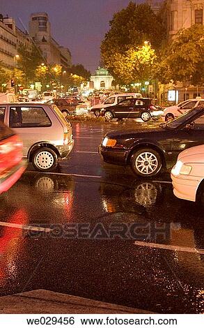 Stock Photograph - Rain and traffic. Cibeles square. Puerta de Alcalß. Madrid. Spain. Fotosearch