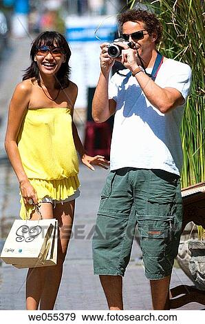 tourist couple taking snapshot on roadside View Large Photo Image Stock Photo - tourist couple taking snapshot on roadside. Fotosearch