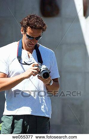 tourist holding camera View Large Photo Image Stock Photo - tourist holding camera. Fotosearch