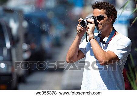 tourist taking snapshot on roadside View Large Photo Image Stock Photo - tourist taking snapshot on roadside. Fotosearch