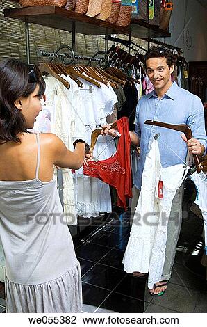 young couple choosing clothes at store View Large Photo Image Stock Image - young couple choosing clothes at store. Fotosearch