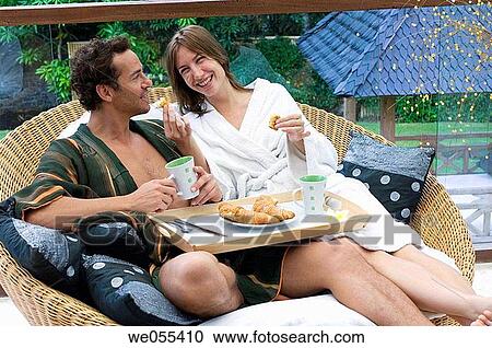 young couple having breakfast on sofa View Large Photo Image Stock Image - young couple having breakfast on sofa. Fotosearch