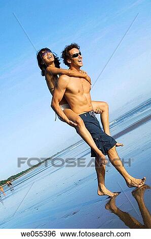 young couple having fun on the beach View Large Photo Image Stock Photograph - young couple having fun on the beach. Fotosearch