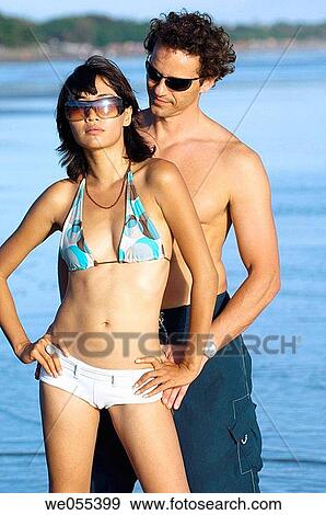 Stock Photo - young couple posing on the beach. Fotosearch