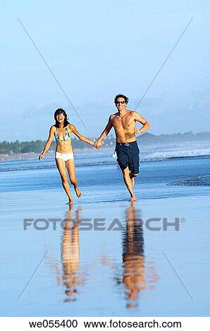 young couple running on the beach View Large Photo Image Stock Image - young couple running on the beach. Fotosearch