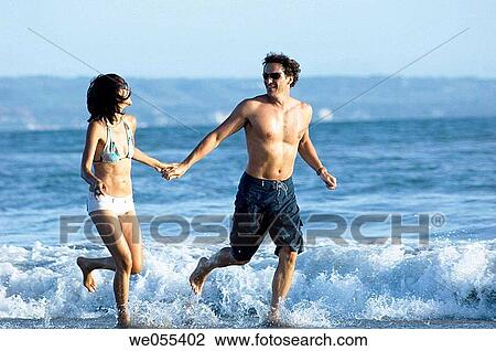 young couple running on the beach View Large Photo Image Stock Image - young couple running on the beach. Fotosearch