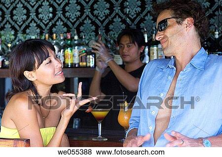 young couple talking and drinking at bar View Large Photo Image Stock Photo - young couple talking and drinking at bar. Fotosearch