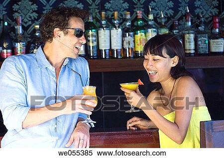 young couple talking and drinking at bar View Large Photo Image Stock Photography - young couple talking and drinking at bar. Fotosearch