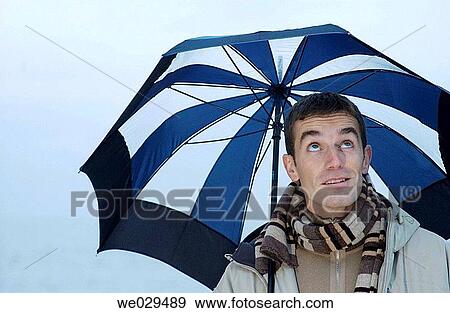 Young man under an umbrella. San Sebastißn-Donostia. Guip·zcoa. Euskadi. Spain View Large Photo Image Stock Photo - Young man under an umbrella. San Sebastißn-Donostia. Guip·zcoa. Euskadi. Spain. Fotosearch