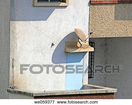 A dish antenna of a television set up on a balcony door. Pune, Maharashtra, India. View Large Photo Image Stock Photo - A dish antenna of a television set up on a balcony door. Pune, Maharashtra, India.. Fotosearch
