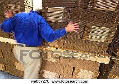 A man leaning against a stack of new empty and flat cardboard boxes View Large Photo Image Stock Photograph - A man leaning against a stack of new empty and flat cardboard boxes. Fotosearch
