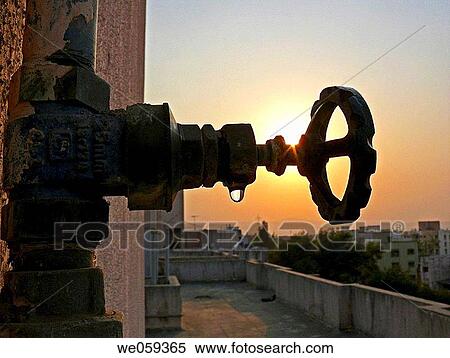A revolving cock, tap of a water pipeline going to an overhead water storage on a building teracce. Vadgaon Budruk. Pune, Maharashtra, India. View Large Photo Image Stock Photography - A revolving cock, tap of a water pipeline going to an overhead water storage on a building teracce. Vadgaon Budruk. Pune, Maharashtra, India.. Fotosearch