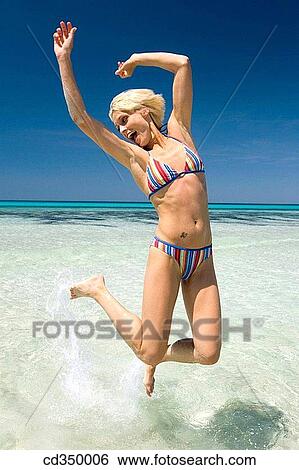 amusement, beach, Arms raised, action View Large Photo Image Stock Photograph - amusement, beach, Arms raised, action. Fotosearch