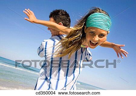 Picture - Arms open, carefree, beach, amusement. Fotosearch