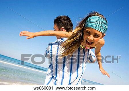 Arms open, carefree, beach, amusement View Large Photo Image Stock Image - Arms open, carefree, beach, amusement. Fotosearch