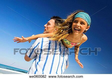 Arms open, carefree, beach, amusement View Large Photo Image Stock Image - Arms open, carefree, beach, amusement. Fotosearch
