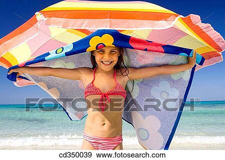 Stock Photo - Arms open, child, beach, amusement. Fotosearch