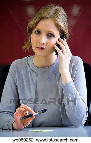 Stock Image - Ball-point pen, blond, blue eyes, business, businesspeople. Fotosearch