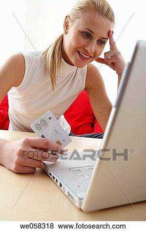 Stock Photo - Bank card, blond, at-home. Fotosearch