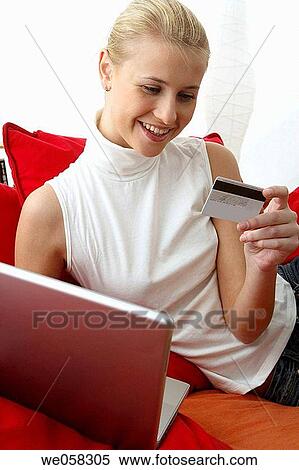 Stock Photography - Bank card, blond, at-home. Fotosearch