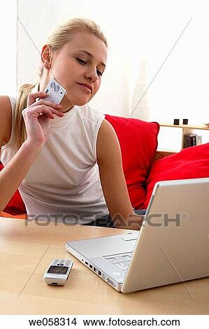 Picture - Bank card, cell phone, blond, at-home. Fotosearch