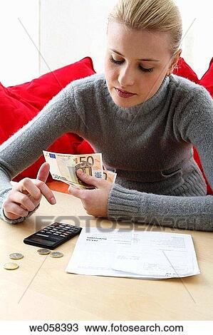 Stock Image - banknote, cash, calculator, bill, at-home. Fotosearch