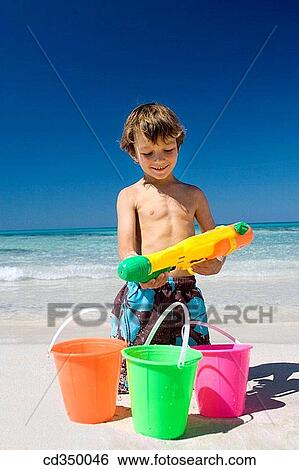 beach, boy, bucket, child, childhood View Large Photo Image Stock Photograph - beach, boy, bucket, child, childhood. Fotosearch