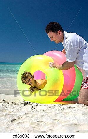 Stock Image - beach, catch, boy, amusement. Fotosearch