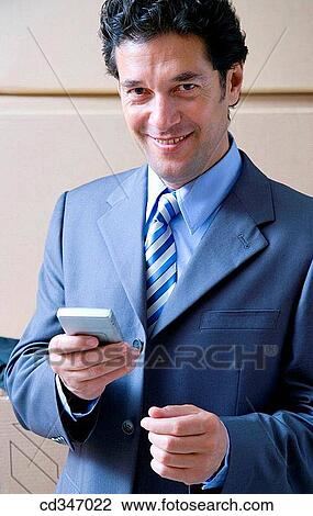 Stock Image - black hair, businessman, businesspeople, cell phone. Fotosearch