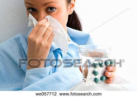 Stock Image - blister-pack, Blow nose, Blowing nose, brunette. Fotosearch