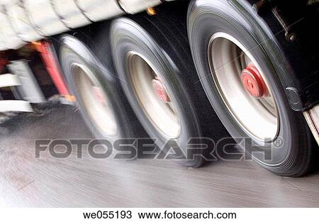 Stock Image - blurred motion, fast, detail, day, asphalt. Fotosearch