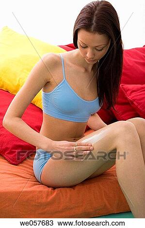 Stock Image - Body care, cellulite, brunette, apply. Fotosearch
