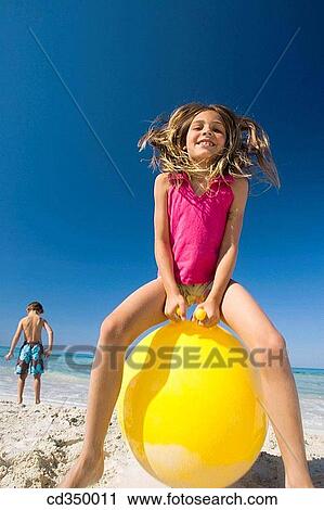 Stock Image - boy, activity, beach, ball, amusement, action. Fotosearch