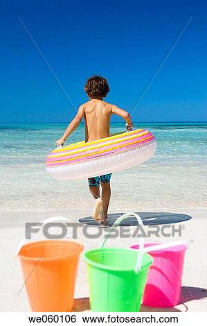Stock Photograph - boy, back view, beach, bathing, bathe, amusement. Fotosearch