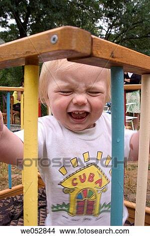 Boy crying inside the crib View Large Photo Image Picture - Boy crying inside the crib. Fotosearch