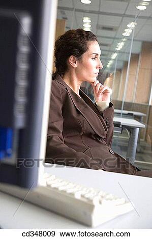 Stock Photo - brunette, businesspeople, business, absorbed. Fotosearch