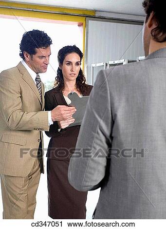 Stock Image - businessman, businesswoman, businesspeople, Attache case. Fotosearch