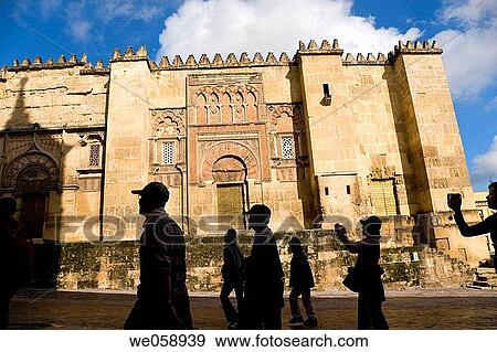 Stock Photo - Cordoba Cordoba Province Spain Tourists passing by west wall of La Mezquita The Great Mosque. Fotosearch