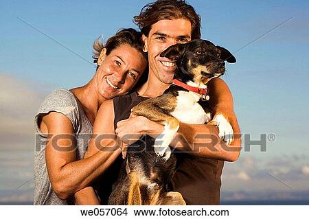 Couple Hugging Their Dog View Large Photo Image Picture - Couple Hugging Their Dog. Fotosearch