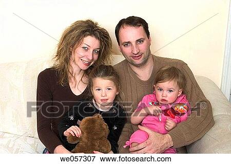 Stock Photo - Couple posing with their two young daughters. Fotosearch