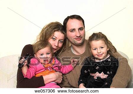 Couple posing with their two young daughters View Large Photo Image Stock Photograph - Couple posing with their two young daughters. Fotosearch