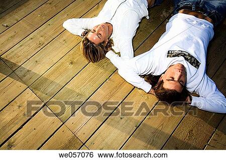 Couple Relaxing On Wood Deck View Large Photo Image Stock Photograph - Couple Relaxing On Wood Deck. Fotosearch