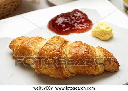 Stock Photo - Croissant jelly and butter on a plate. Fotosearch