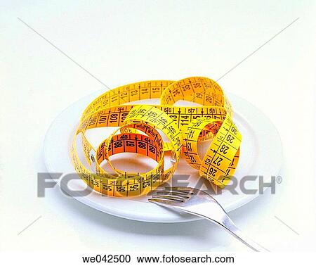 Stock Image - Dish, fork and tape measure. Fotosearch