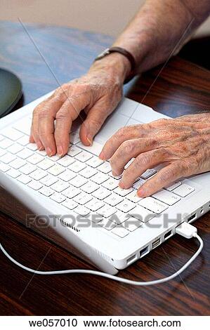 Elderly woman types on a notebook computer View Large Photo Image Stock Image - Elderly woman types on a notebook computer. Fotosearch