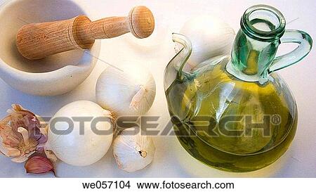 Picture - Garlic, olive oil, white onions and mortar with wooden pestle. Fotosearch