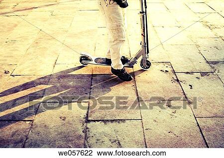 Girl on a scooter. Sant Salvador promenade. El Vendrell. Baix Pened? s. Tarragona province. Catalonia. Spain. View Large Photo Image Stock Image - Girl on a scooter. Sant Salvador promenade. El Vendrell. Baix Pened? s. Tarragona province. Catalonia. Spain.. Fotosearch