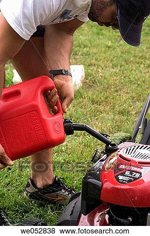 Man filling up the mower tank View Large Photo Image Stock Photo - Man filling up the mower tank. Fotosearch