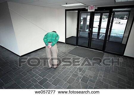 Stock Photo - Man posing in the lobby of an office building. Fotosearch